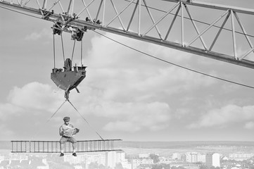 Retro styled handyman with a newspaper at construction area 