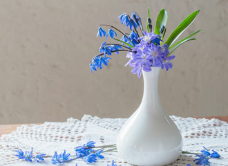 blue snowdrops in vase on a white background