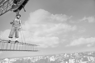 Professional builder dressed in vintage outfit posing on a cross