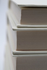 An all white books pile. Suitable to be used like a background.