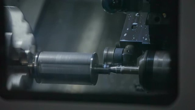 A part of the machine is spinning very fast. We can also see a conveyor belt running.
