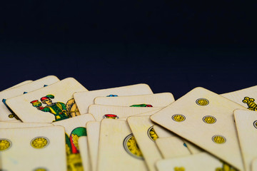 Italian suits playing cards with copy space. Tilt-shift effect applied.