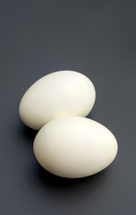 Duck eggs on a black background.