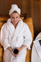 Woman in bathrobe with coffee