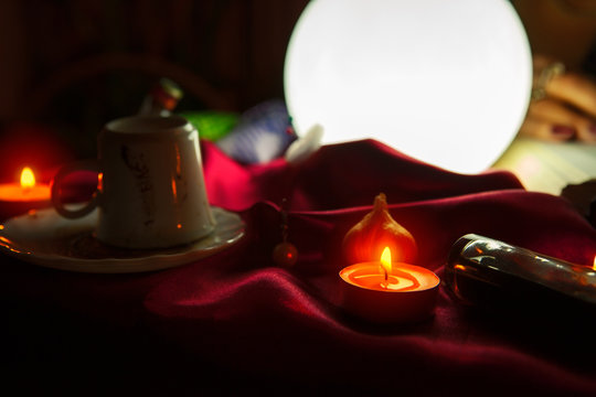 Crystal ball and candles for fortune telling