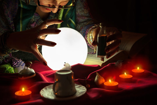 Fortune teller woman staring at crystal ball