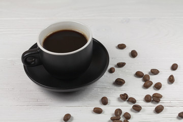 coffee mug and coffee breans on wood backgound