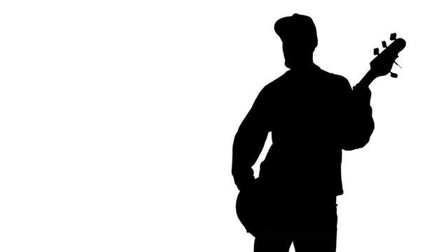 Silhouette of musician with bass guitar