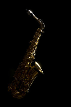low key vintage alto saxophone and light in the dark background