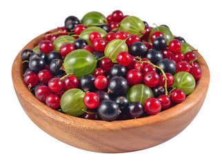 Various kinds of fresh berries in a wooden bowl on a white