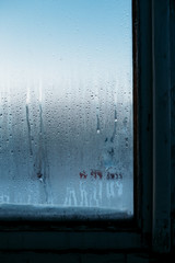 Autumn rain, the inscription on the sweaty glass mark window sunrise