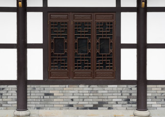Traditional chinsese windows with brick and white wall