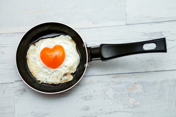 Fried egg in shape of heart,romantic breakfast