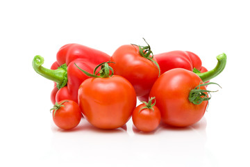 Sweet peppers and tomatoes on a white background