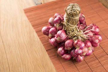 shallots group on wood and bamboo background