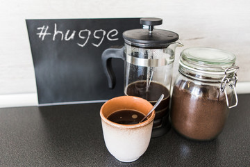 Breakfast with natural coffee. Against a chalkboard background with a hashtag hugge