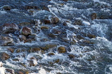 Raging water in threshold of the mountain river