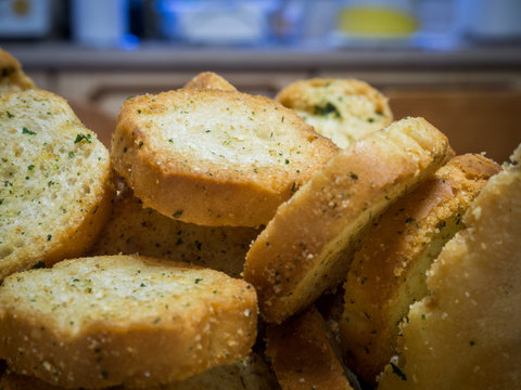 A pile of mini toasts with garlic