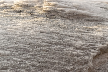Grey Melted Snow on the Ground in Early Spring