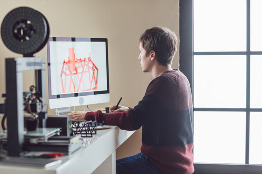 Young Caucasian man designing object for 3d printing.