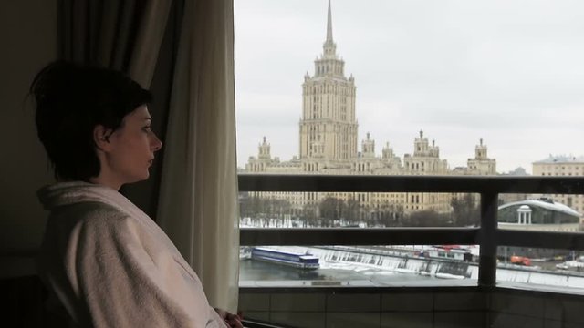 girl is sitting in a chair in a hotel room