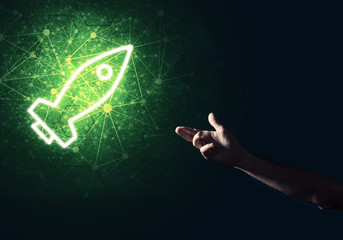Man palm presenting Rocket web icon as technology concept