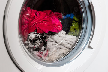 Washing machine door, clean colorful clothes, yellow, blue plush terry