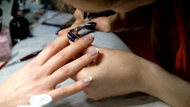 Manicure master works with the client