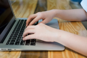 Woman using computer laptop in coffee shop