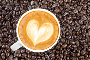 Coffee cup and coffee beans on table