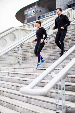 Couple Running Down The Stairs