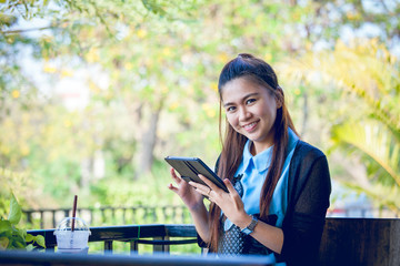 Young woman using tablet in coffee shop