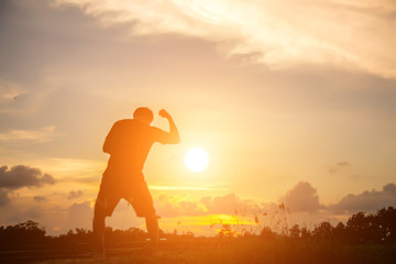 Man show hands silhouette sunset background 