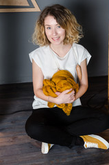 Young woman sitting and holding merino wool near LOVE sign