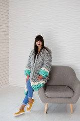 Young fashionable woman in merino wool jacket