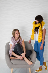 Two friends in merino wool scarfs having fun