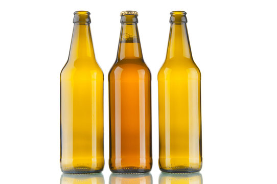 One bottle with beer and two empty beer bottles on white background