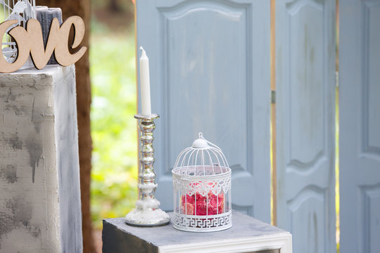 decoration for wedding registration in the form of a bird's cage, a blue wooden door and candles