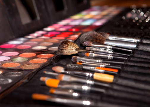 Tools and paints for make-up, pallets with shadows and brushes