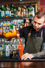 The bartender making cocktail