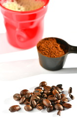 Coffee beans, powder and red cup.