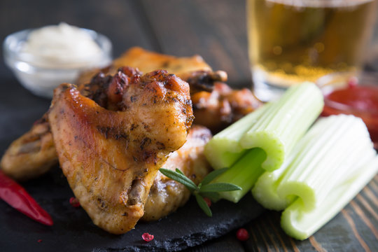 Fried chicken wings with celery and beer