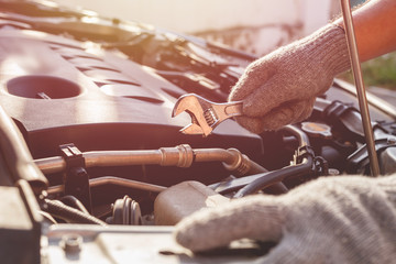 Technician checking or fixing engine of modern car