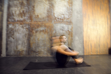 Young athletic man practicing acroyoga. Balancing . Fit active pair yoga time. Sporty handsome man. Training time. Asana 