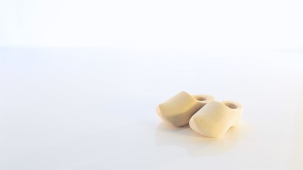 Pair of Small Dutch Wooden Shoes Isolated on a Clear White Background