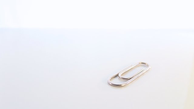 Silver Paperclip on White Table Workspace