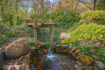 Landscape with small waterfall in dutch spring Keukenhof. Unforgettable show