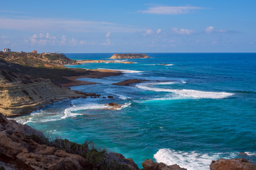 Fototapeta na wymiar Wonderful seascape - blue waves splash near the rocky shore