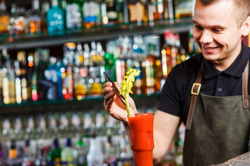 The bartender making cocktail