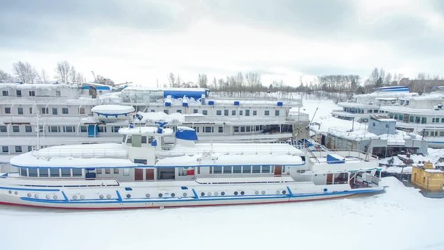 White blue passenger motor ships in winter parking in  backwater